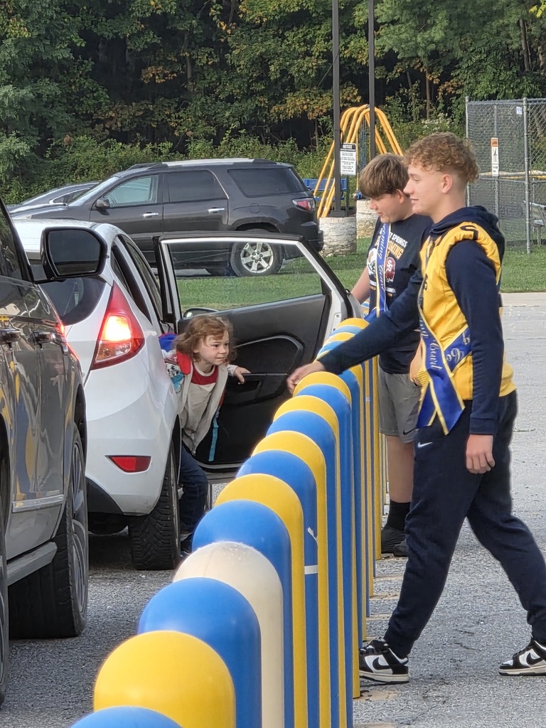 These are pictures of high school students opening car doors and greeting students.