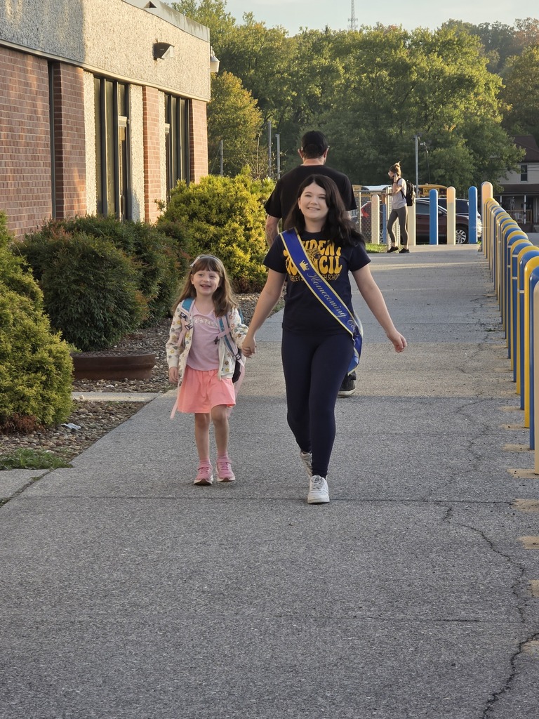 These are pictures of high school students opening car doors and greeting students.