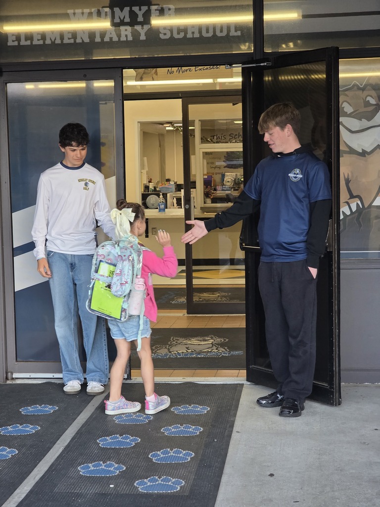 These are pictures of high school students opening car doors and greeting students.