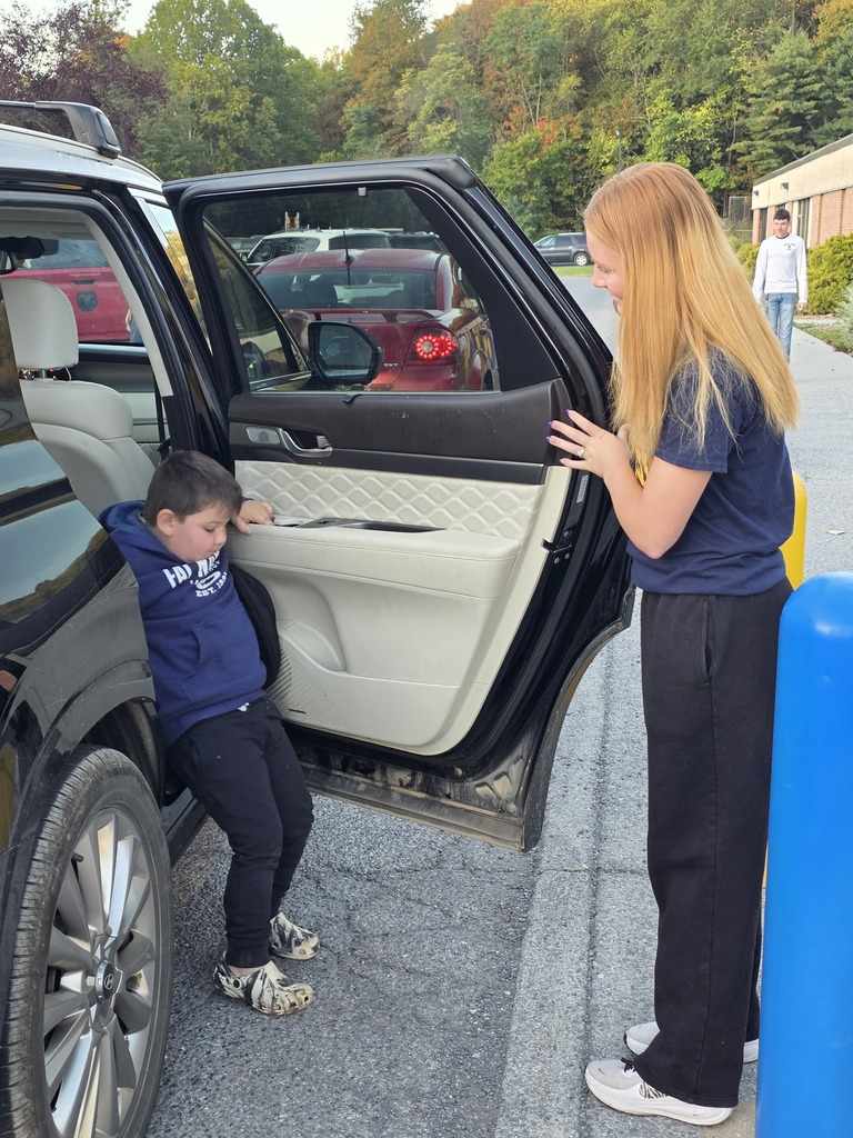 These are pictures of high school students opening car doors and greeting students.