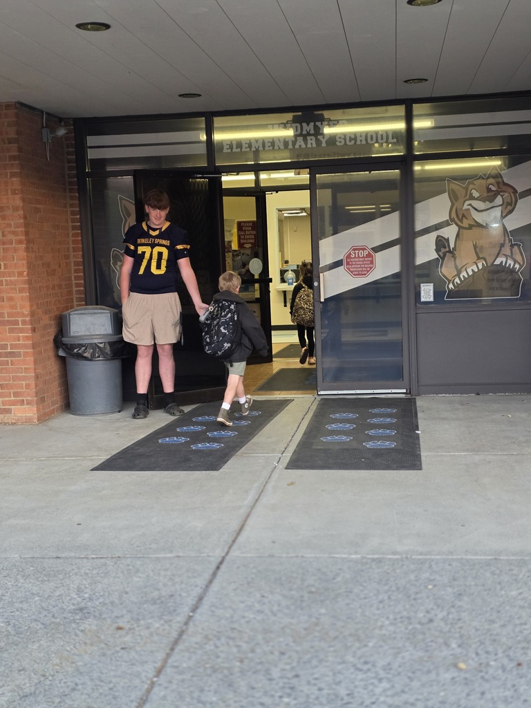 These are pictures of high school students opening car doors and greeting students. 