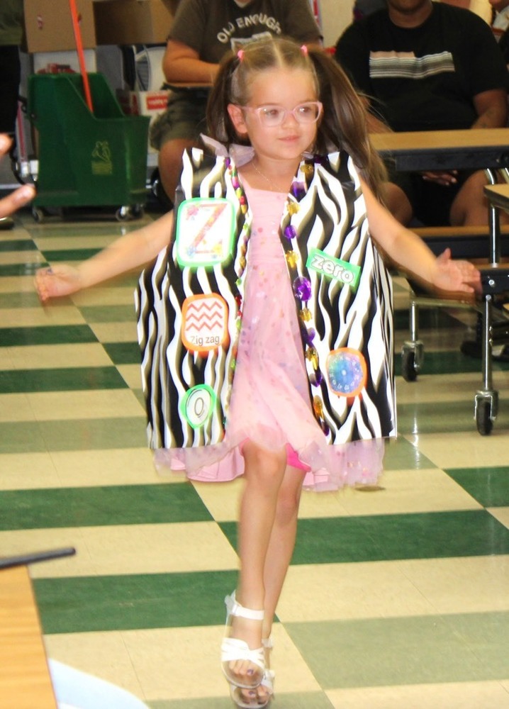 kindergartener with a zebra vest representing the letter z in The kindergarten fashion show