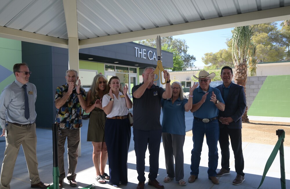 board cutting the ribbon