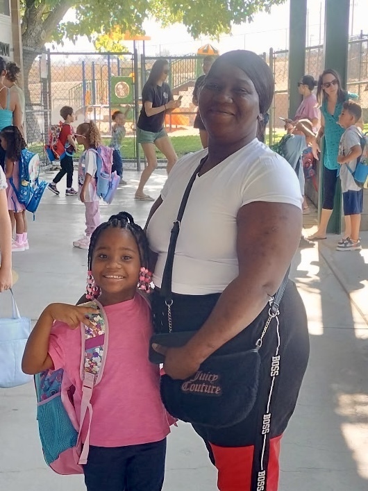 student posing with mom 