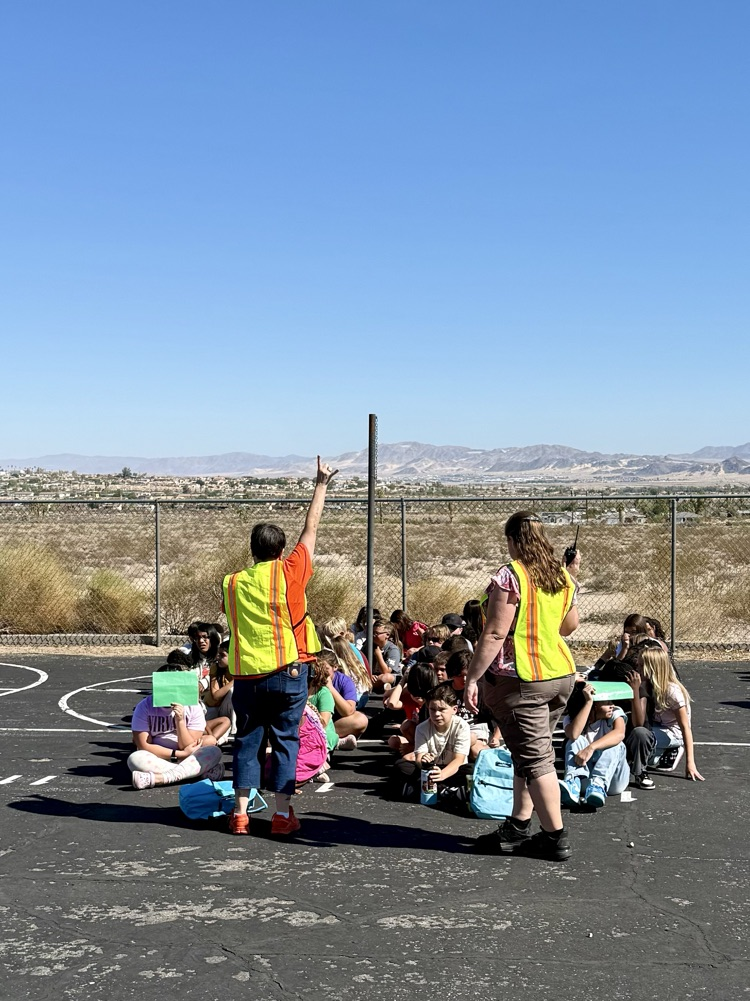 5th & 6th grade teacher standing with students during drill