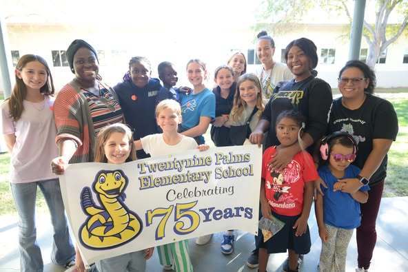 students and parents holding sign for parade