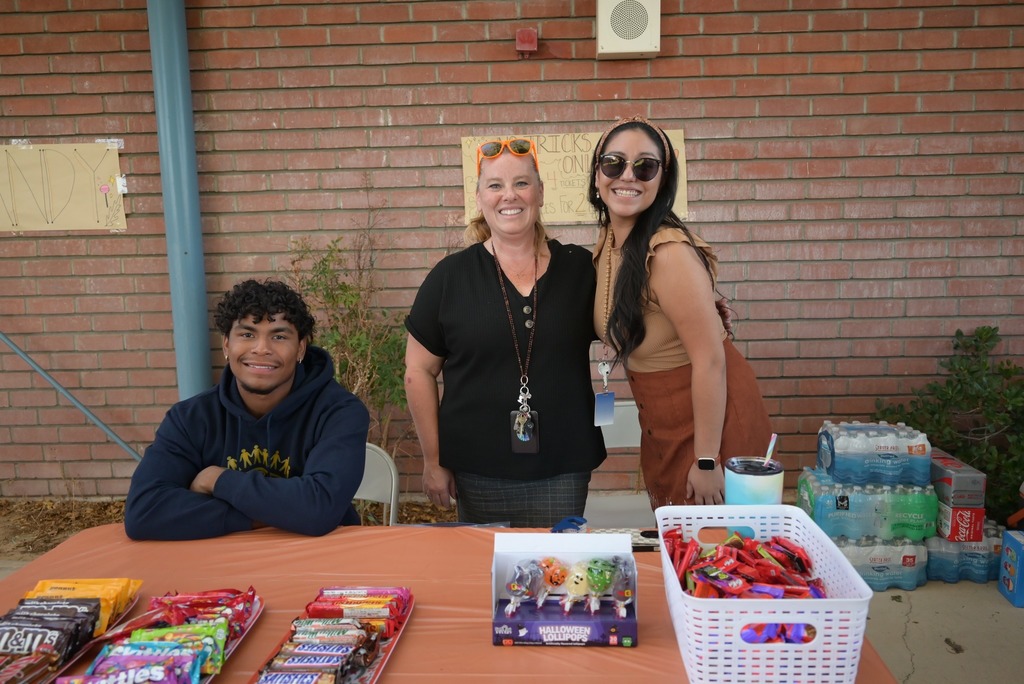 student and staff volunteers at fall fest booth