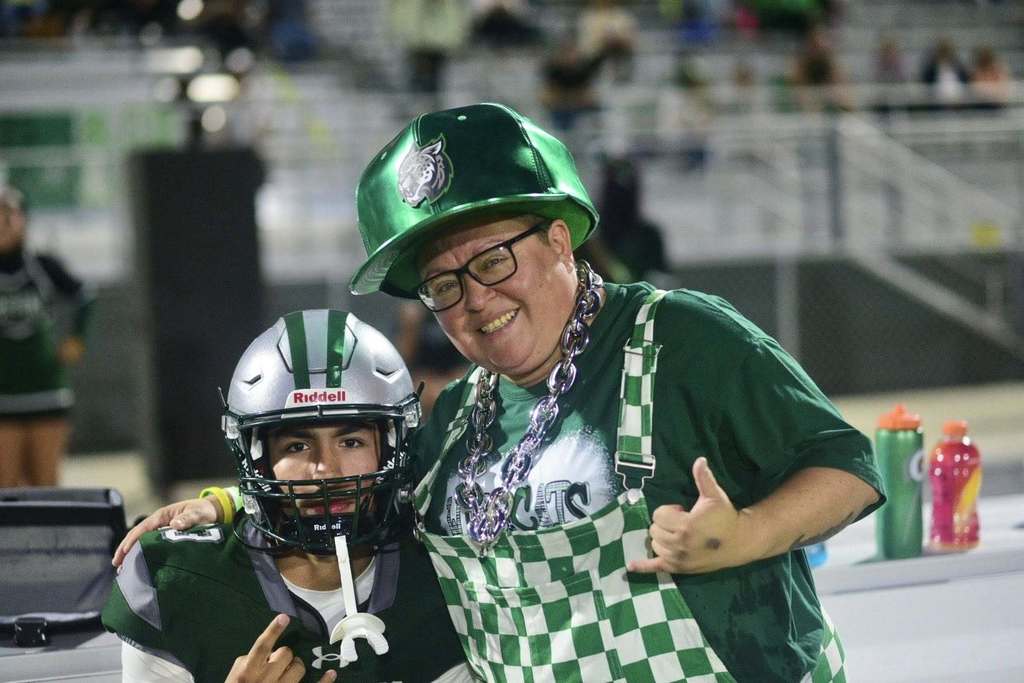 photo of football player and staff member