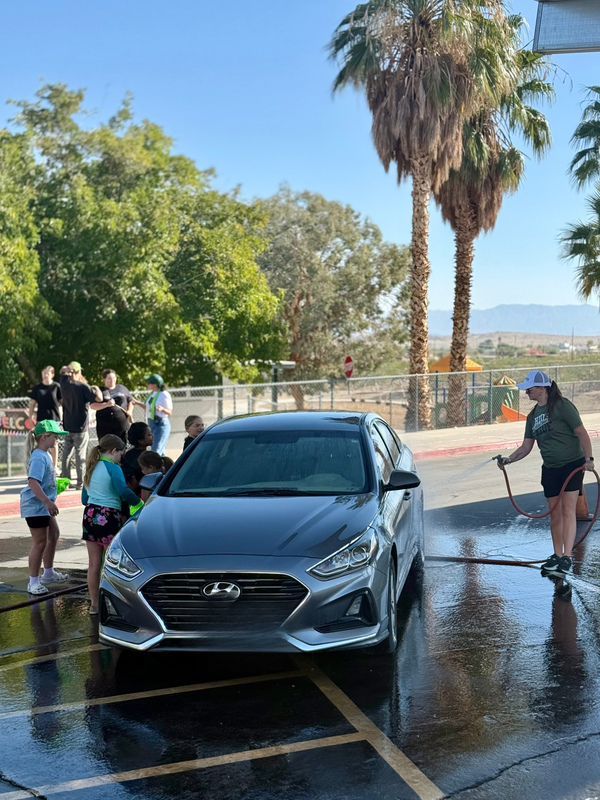 Ms. St. Martin and student leaders washing cars