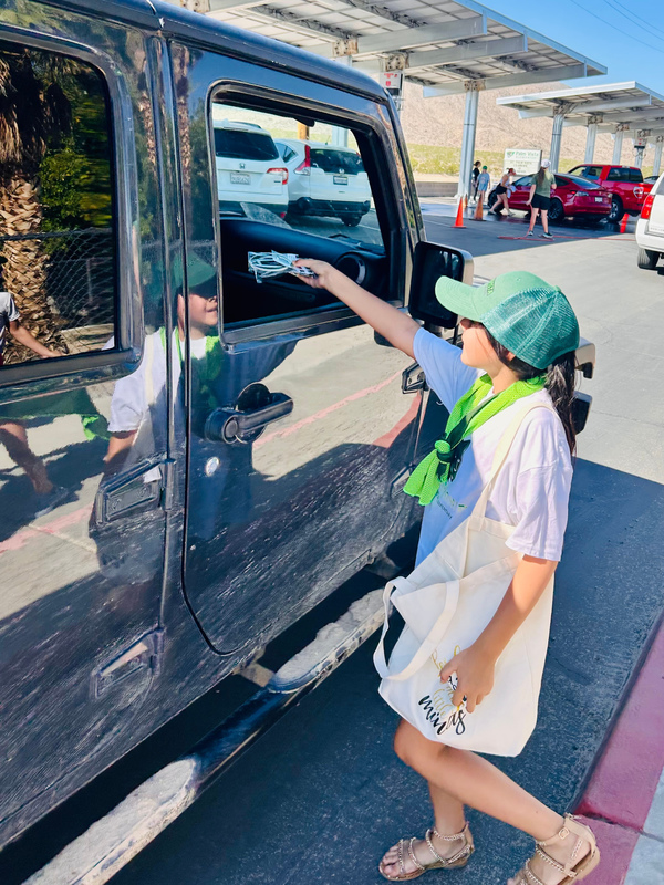 Student Leader Pebbles Garcia handing out swag