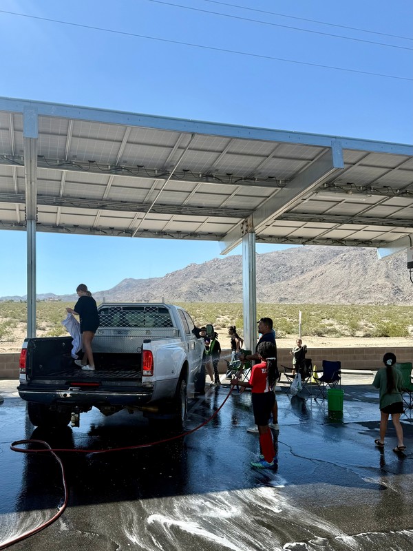 student leaders washing the biggest truck