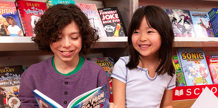 two kids reading Dog Man