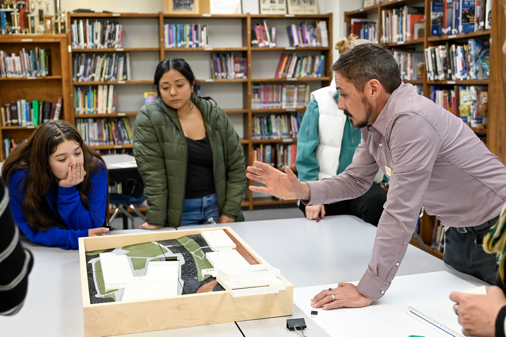 Architects and Design Advisory Committee members review 3D printed design of school facilities.