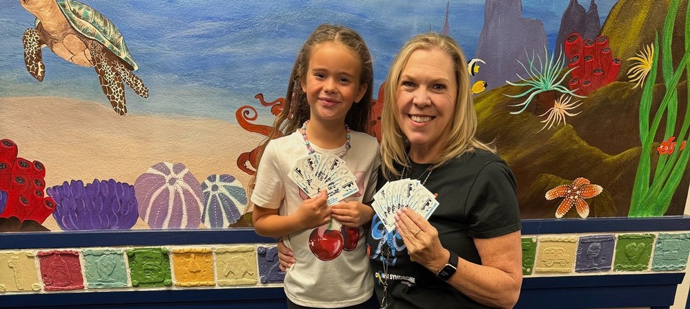 person and child posing with coffee cards