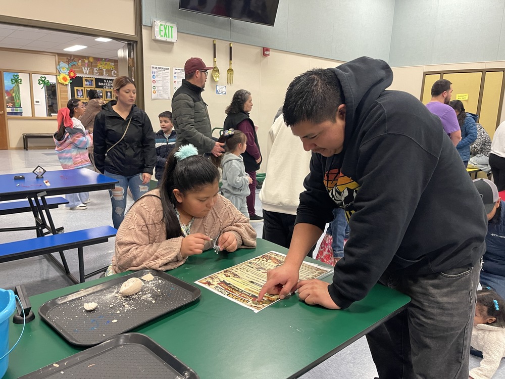 Student and father identify toy dinosaur species