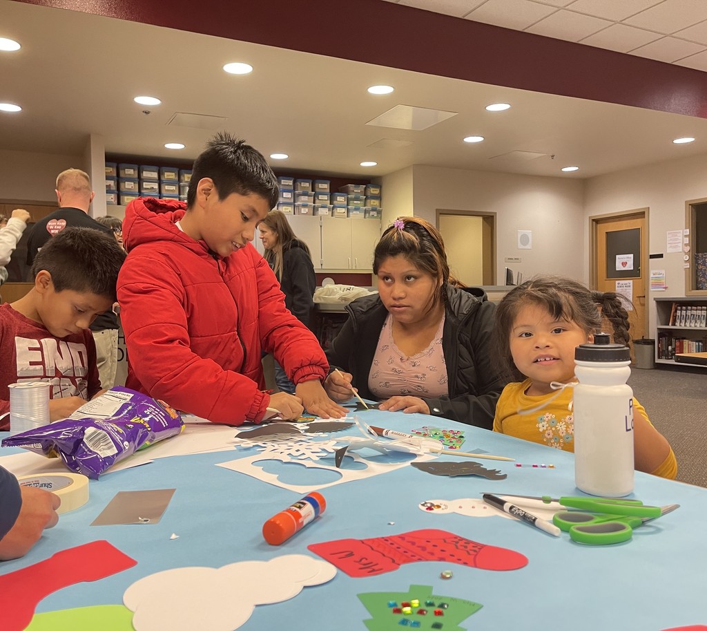 A famly crafts together for art night 