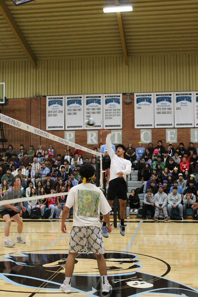 A Riverside student jumps over new Pirate decal to tip the ball over the net