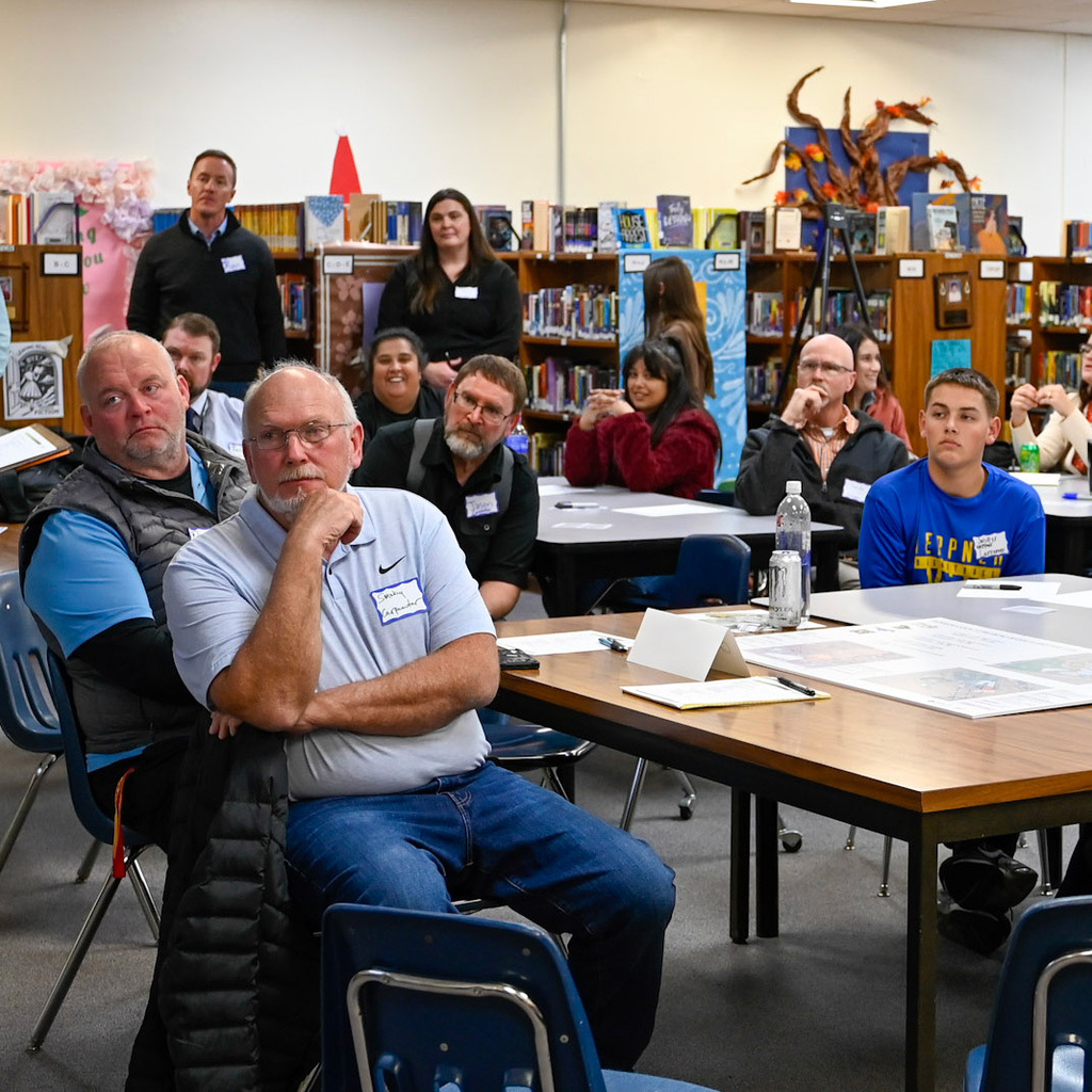 Community members listen intently