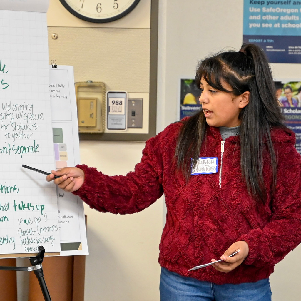 Student points at note pad