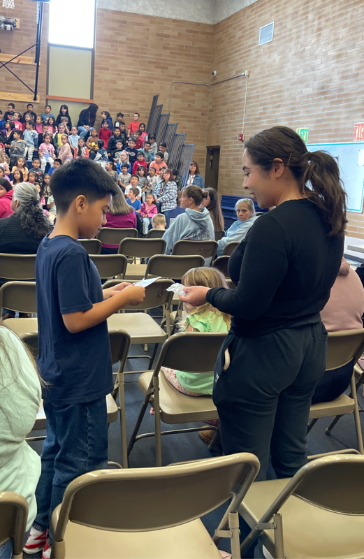 Student hands a veteran a gift