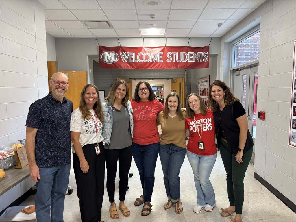group of adults smiling for a group photo