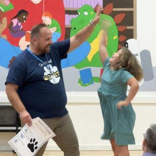 Brian Smith High fiving a student