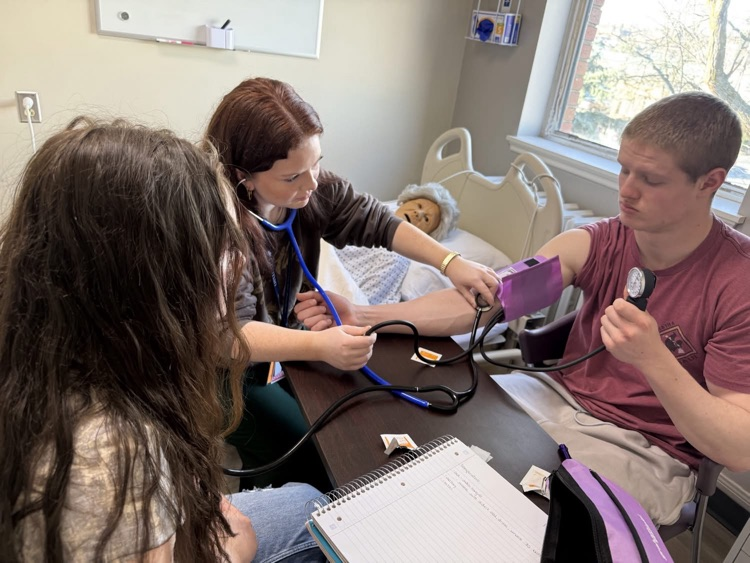 student taking blood pressure