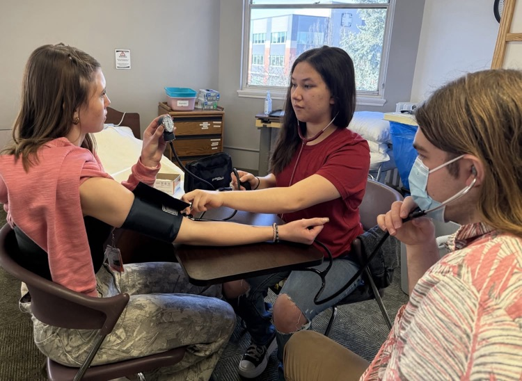 student taking blood pressure