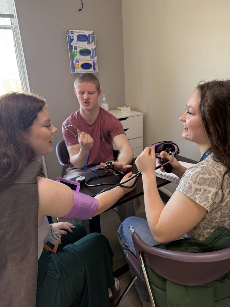student taking blood pressure