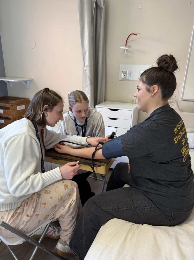 student taking blood pressure