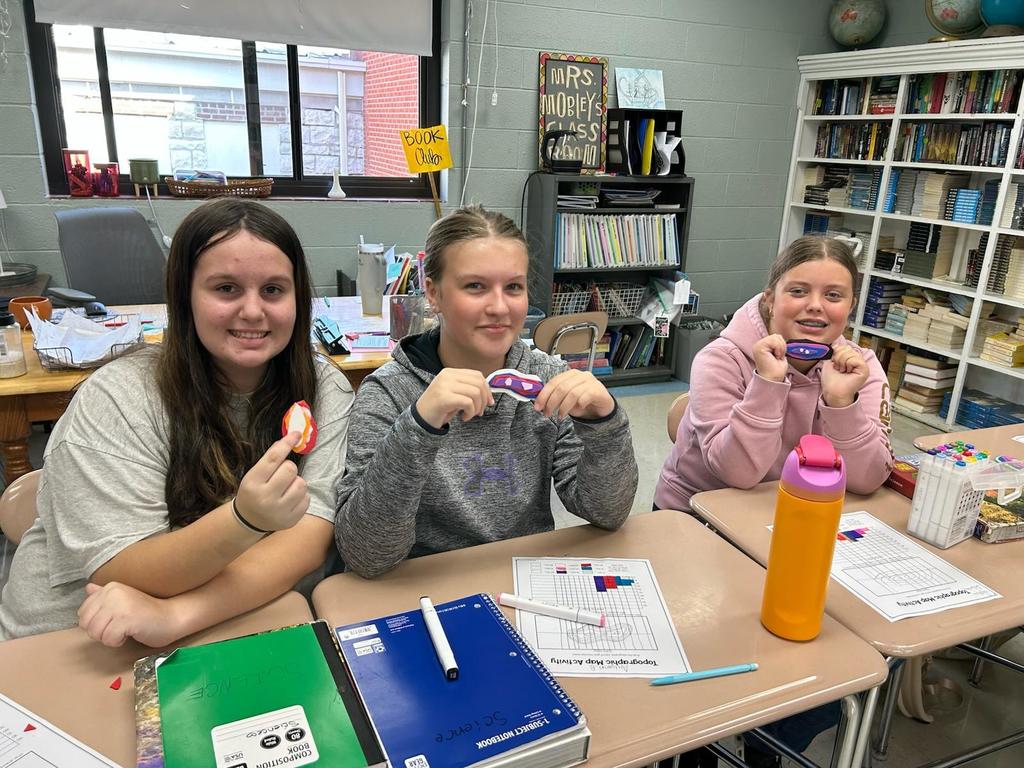 Students showing their topographic map models