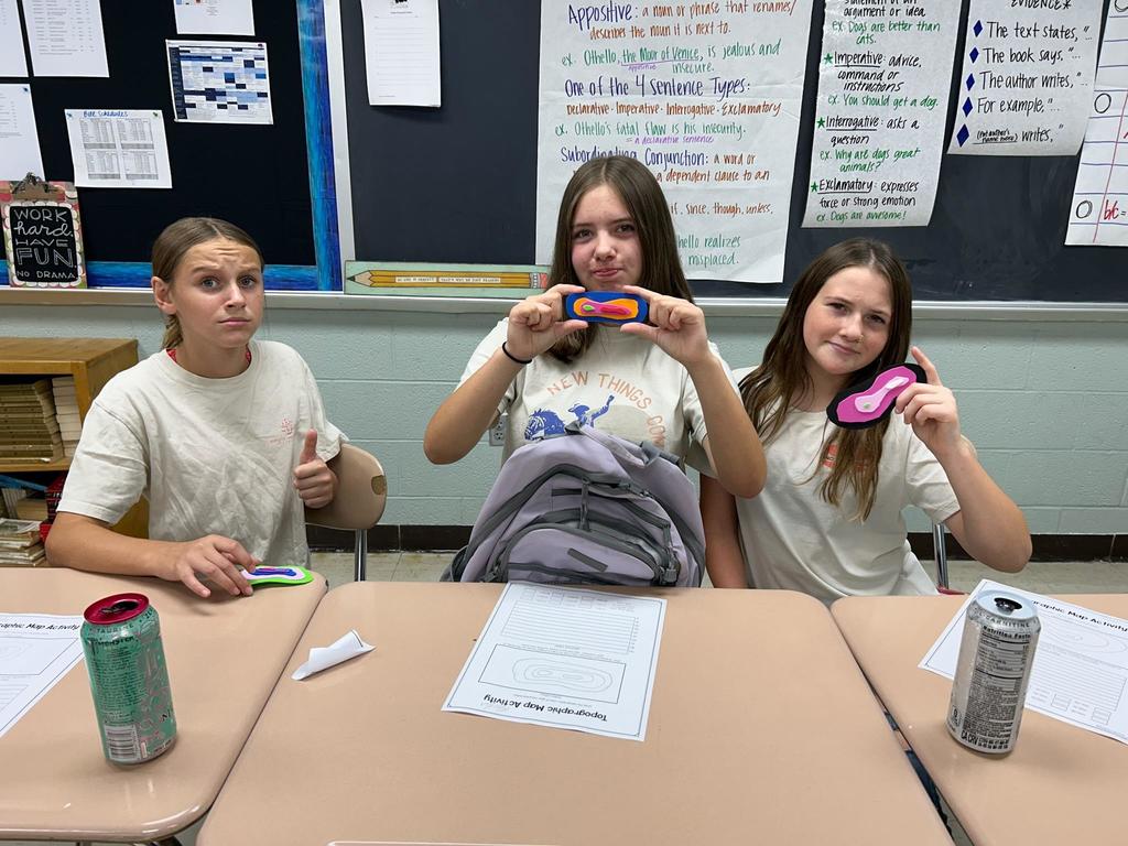 Students showing their topographic map models