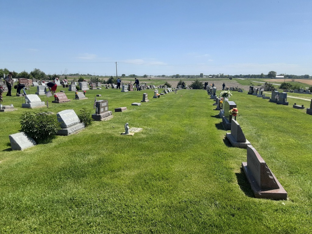 Moulton-Udell High School students doing their civic duty and good deed for the day by placing flags on veterans' graves at two cemeteries north of town on May 11th .