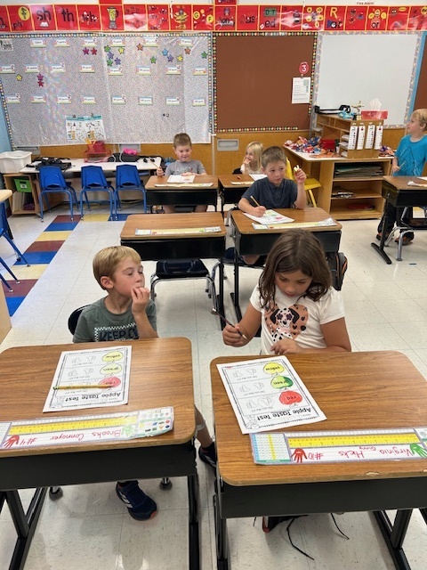 Mrs. Komor's class tasting apples.