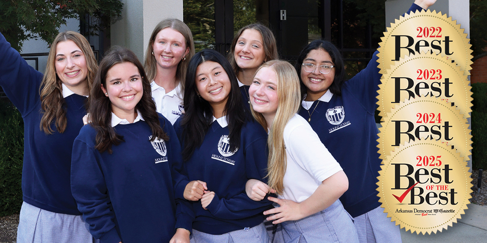group of seven girls in school uniform standing closely together and smiling at camera