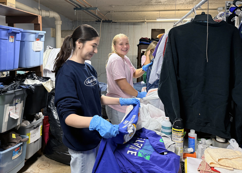 two students organizing clothing