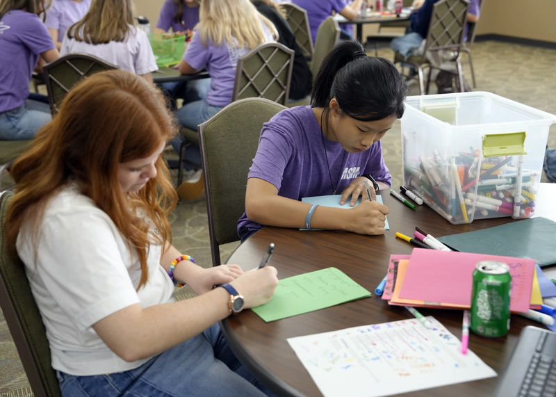 two students writing handmade cards