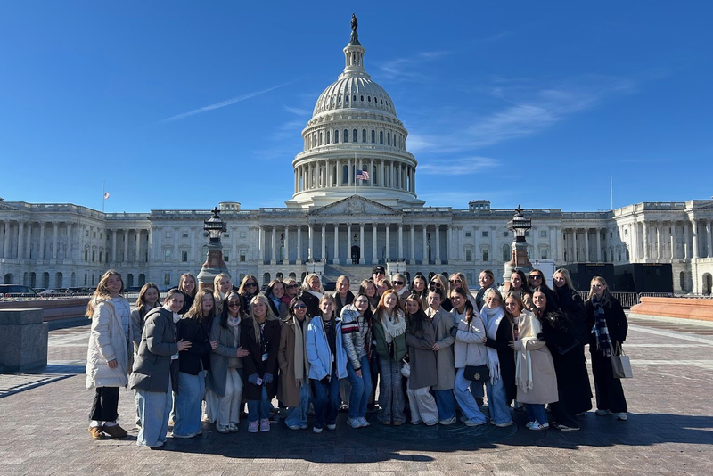 large group of students stand outside the U.S. Capitol building