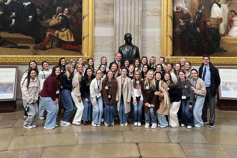 large group of students standing with Congressman French Hill in U.S. Capitol building