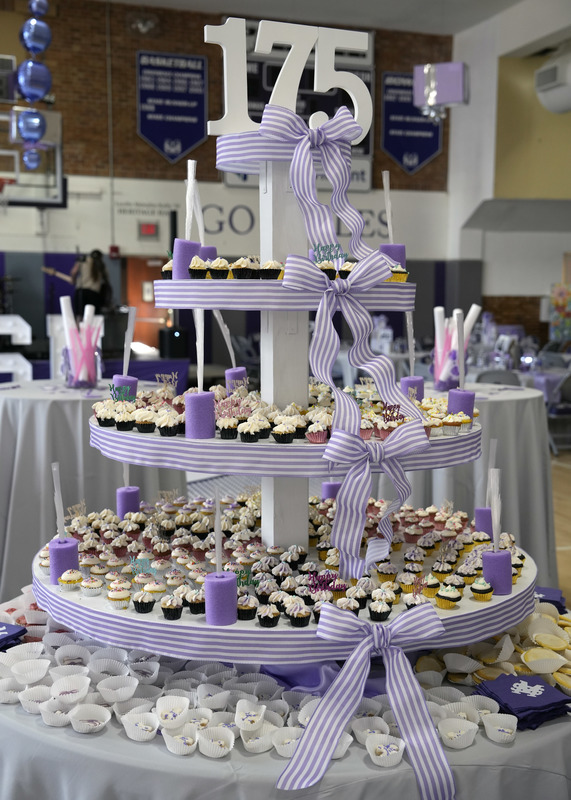 large tiered structure filled with mini cupcakes and cookies