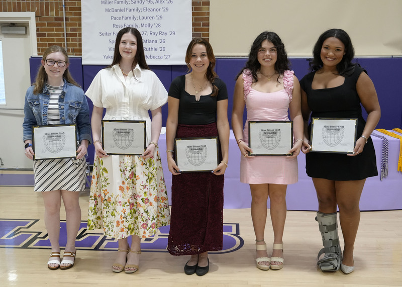 five students holding award certificates