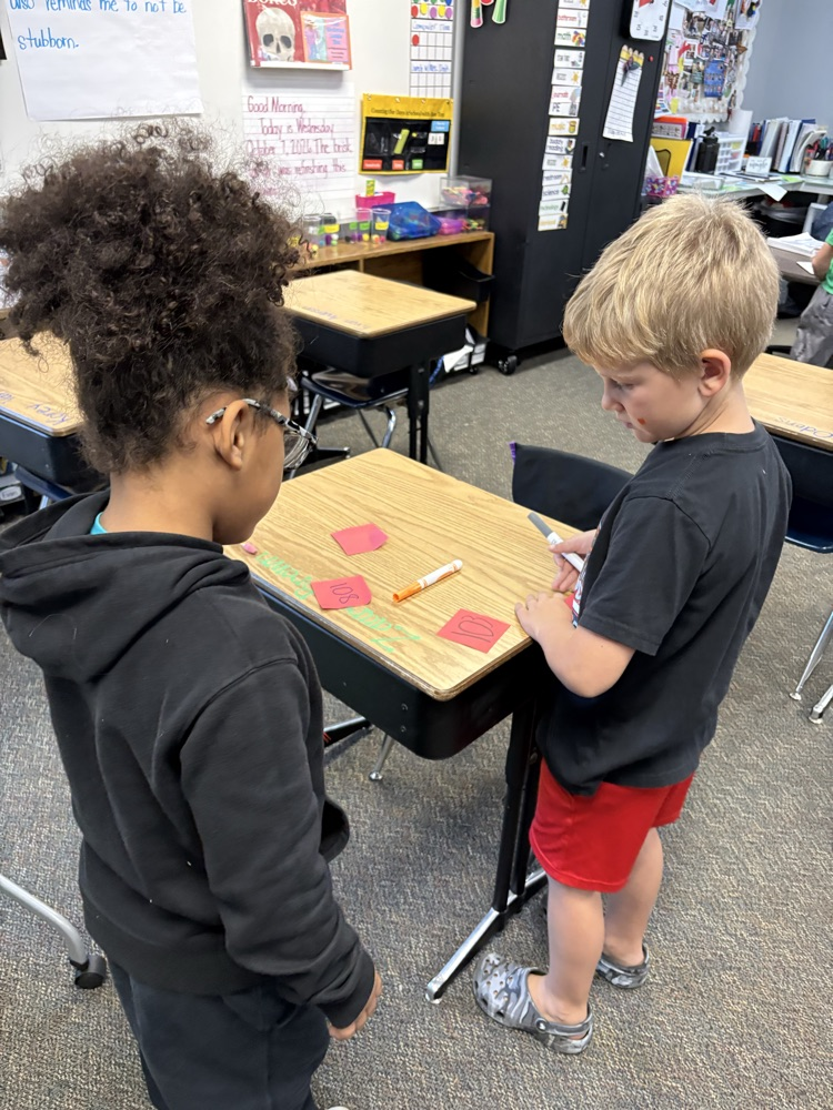 boys using post its to find 10 less and 10 more of a number