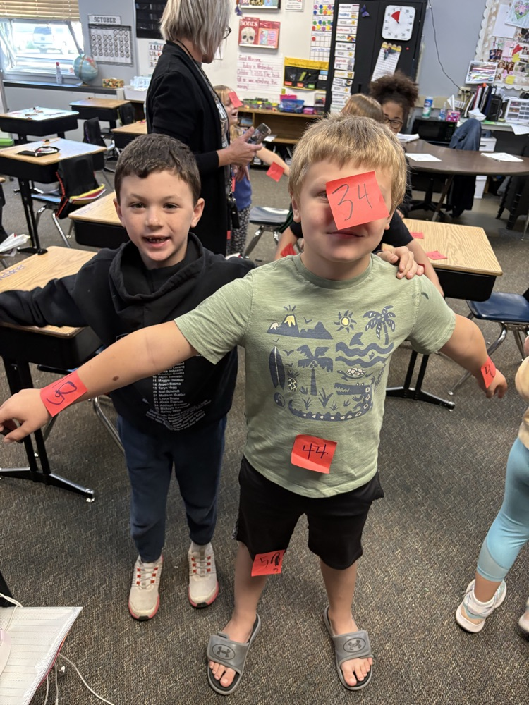 boys using post its to find 10 less and 10 more of a number