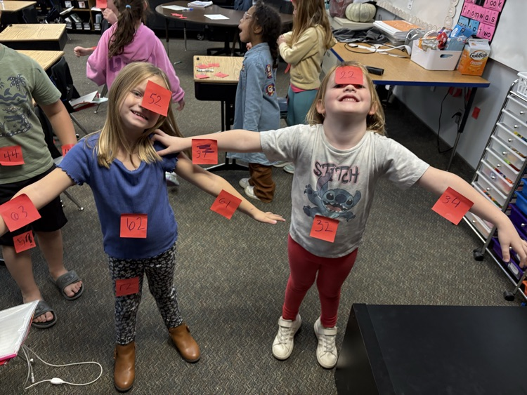 boys using post its to find 10 less and 10 more of a number