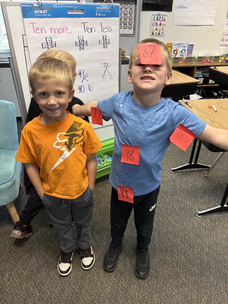 boys using post its to find 10 less and 10 more of a number