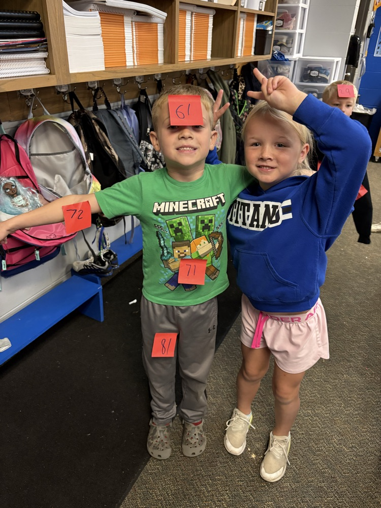 boys using post its to find 10 less and 10 more of a number