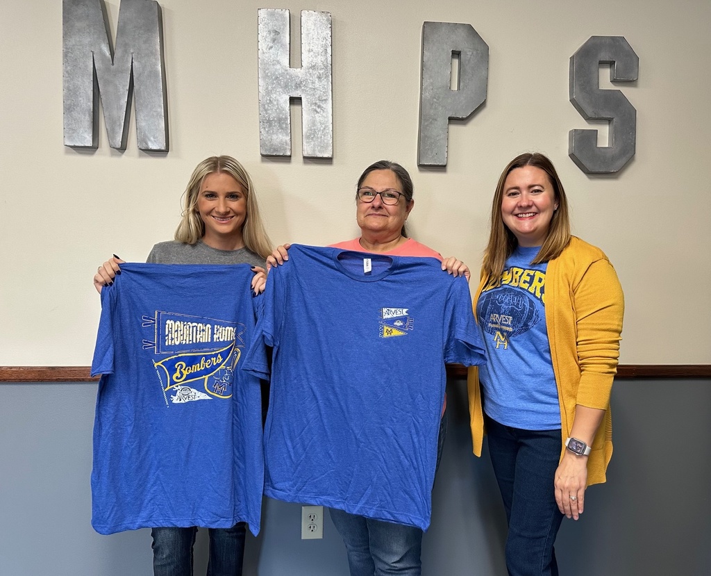 teachers posing with shirts