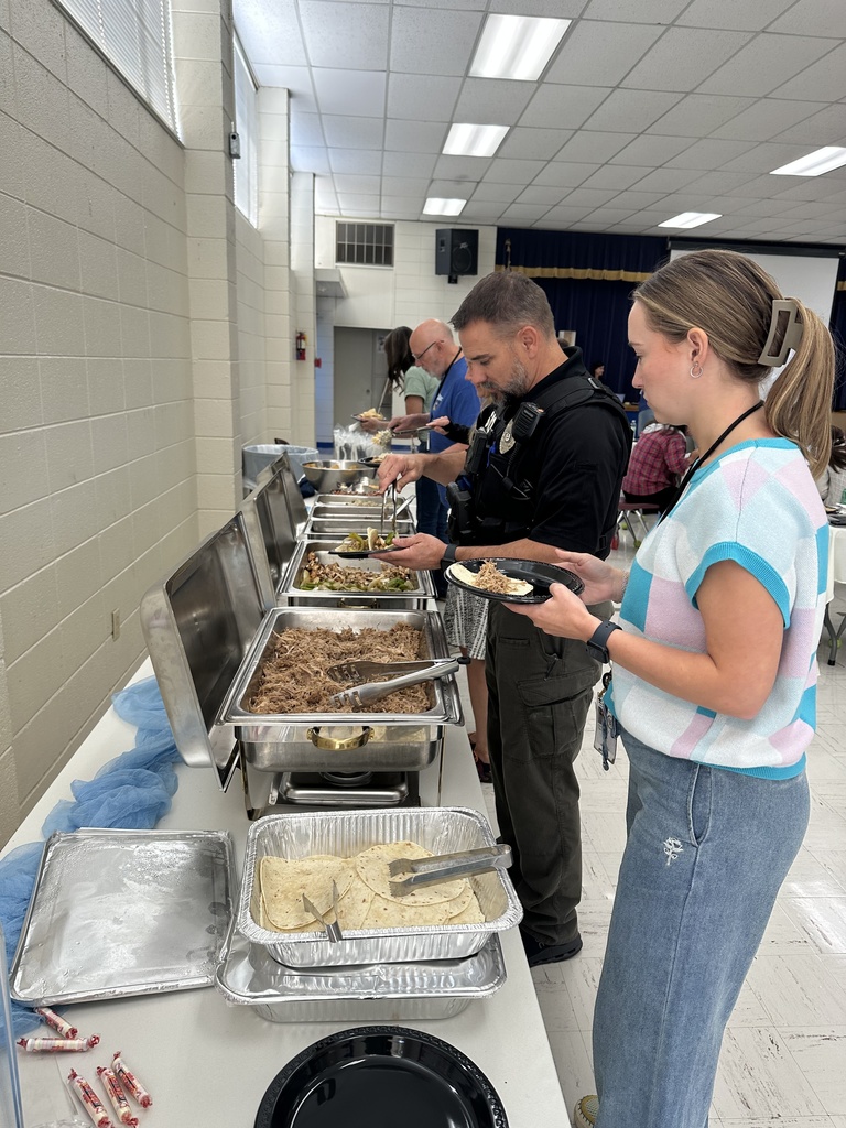 adults getting food from buffet