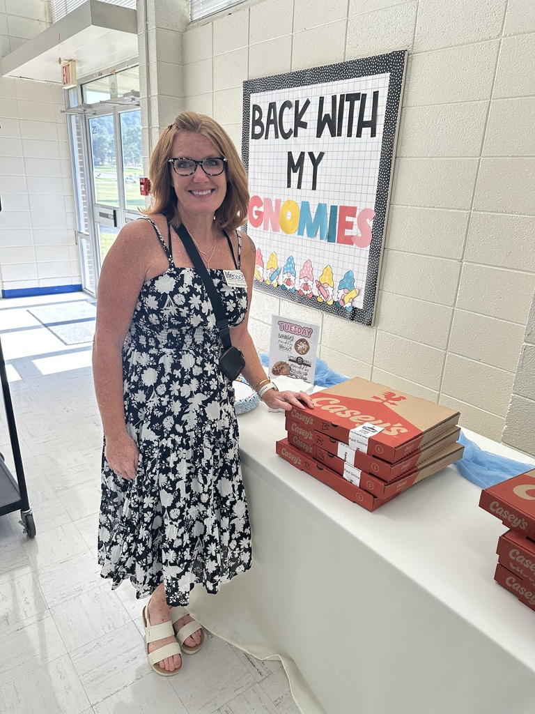 a lady with pizzas from casey's gas station
