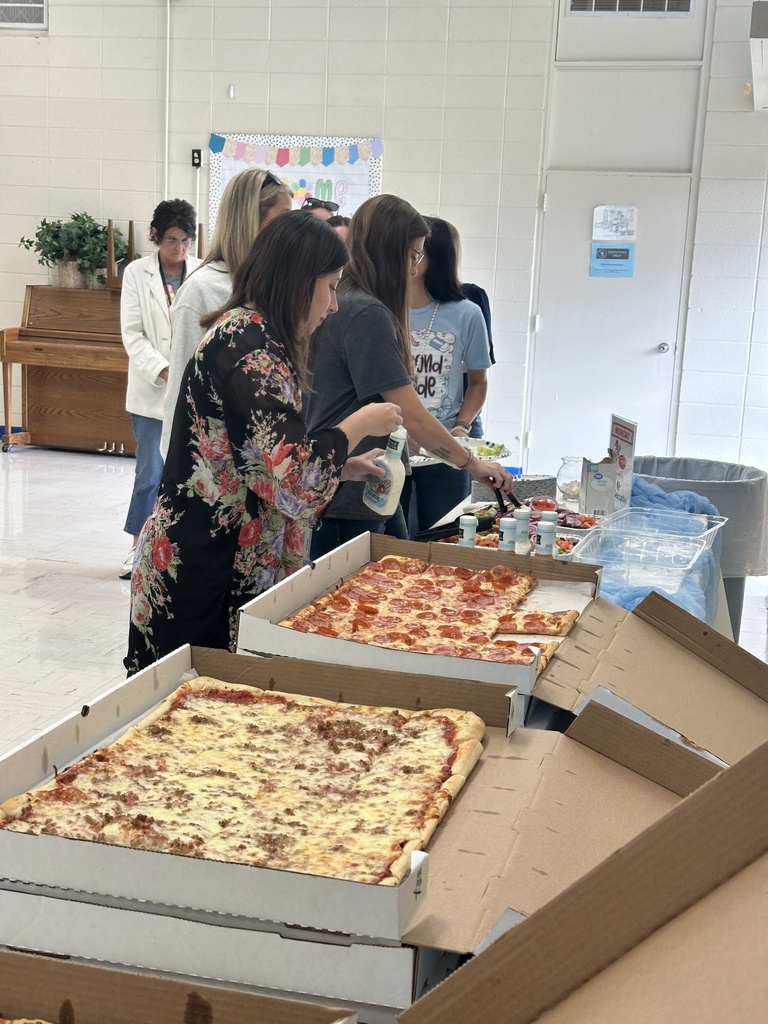 teachers with large pizzas